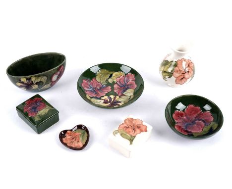 A selection of Moorcroft 'Hibiscus' pattern ceramics, tubeline decorated with flowers, most on a green ground, painted and im