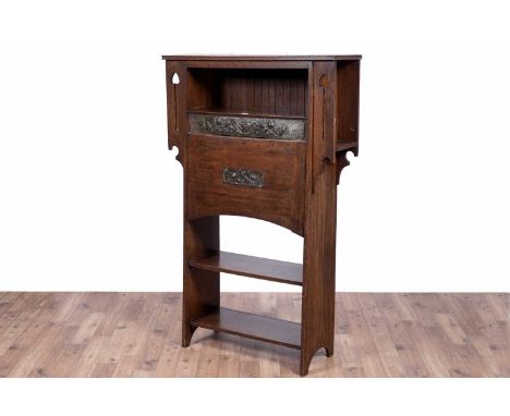 After Liberty: an early 20th Century oak Arts and Crafts bureau, with shelf above embossed copper panels and fall front flap 