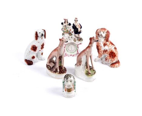 A collection of Victorian Staffordshire pottery, to include: a flatback clock figure group; a pair of seated greyhounds; a ma