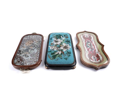 A Victorian beadwork tray, of shaped oblong from, the central floral beadwork embroidery within a glazed inlaid walnut frame,
