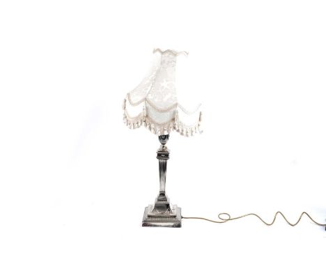 A Walker and Hall silver plated table lamp and shade, the reeded and fluted column surmounted by urn finial, 61cms including 