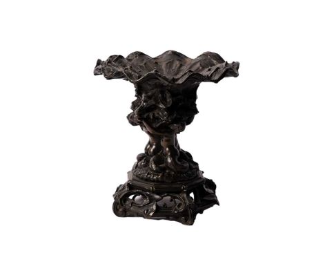 A 19th Century patinated bronze tazza or table centrepiece, the shell pattern bowl on lilies and bull rushes, held by three m
