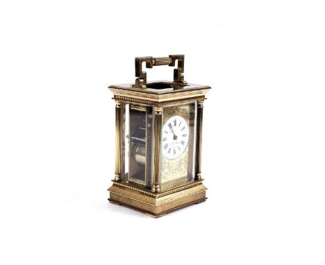 J.W. Benson of London: a brass carriage clock, the white Roman dial within floral engraved brass surround, with platform leve