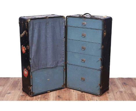 The Oshkosh Trunk Co: an early 20th Century steamer/wardrobe trunk, opening to reveal a hanging rail, briefcase and five grad