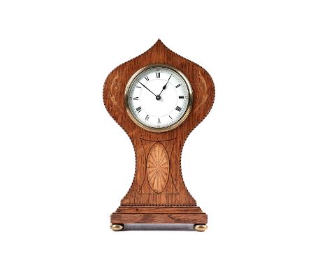 An Edwardian inlaid oak and barber-pole strung balloon-shaped mantel clock, with white enamel Roman dial, the brass movement 