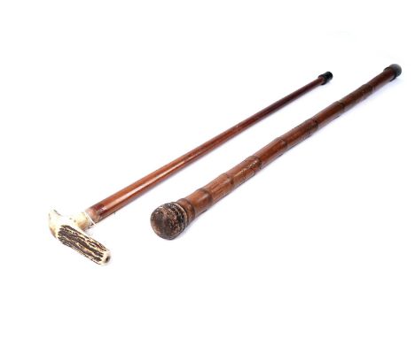 A Chinese bamboo walking stick, with carved figural decoration, 89cms long; together with an early 20th Century walking stick