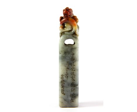 A mid 20th Century Chinese mixed colour soapstone seal of a young dragon resting on a steele, H. 12cm.