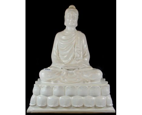 A large white glazed ceramic figure of the seated Buddha, H. 54cm.