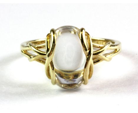 A 9ct yellow gold Uri Geller limited edition oval cut cabochon rock crystal healing ring, (R.5).