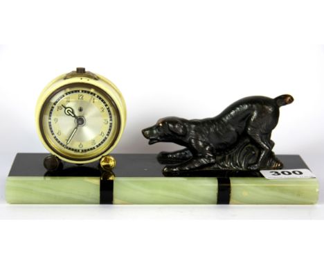 An Art Deco figural alarm clock with green and black onyx base, L. 22.5cm.