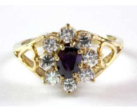 A 9ct yellow gold amethyst and white stone set cluster ring, (K.5).