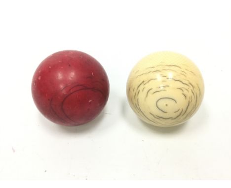 TWO EARLY 20TH CENTURY IVORY SNOOKER BALLS, one red, one white (2)