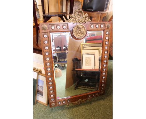 Large French style bevel edge mirror on walnut frame with applied ceramic plaques with applied surmounted gilt wreath. 77cm x