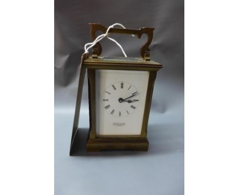 A Searle & Co Royal Exchange brass carriage clock, with beveled glass panels 