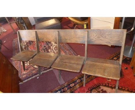 An early 20th century oak folding bench for four 