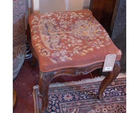 A mid 19th century French carved oak stool, with tapestry upholstery, raised on cabriole legs 