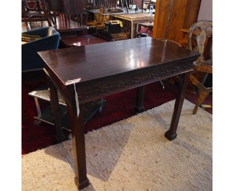 A Chippendale style mahogany console table, with carved and pierced fretwork, raised on ball castors, H.84 W.102 D.58cm 