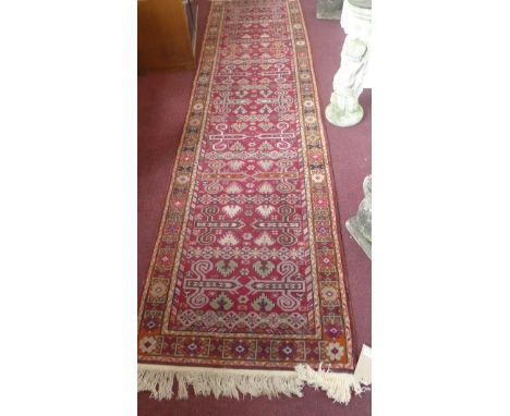 A 20th century Afghan runner, with geometric design, 300 x 80cm (a/f) 
