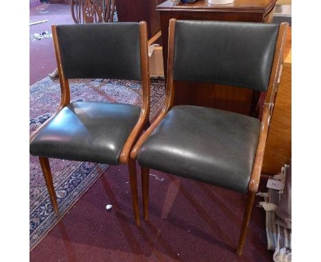 A pair of vintage 'Benchairs' chairs, with green leather upholstery 