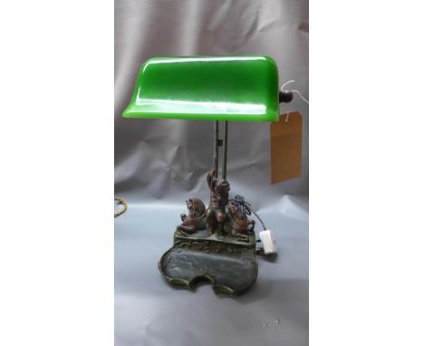 A 20th century bankers lamp, the resin base in the form of a putti and two horses 