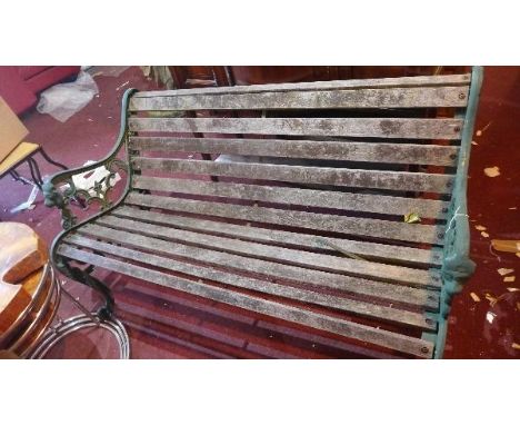 An early 20th century green painted cast iron bench, with weathered teak slats, (a/f) 