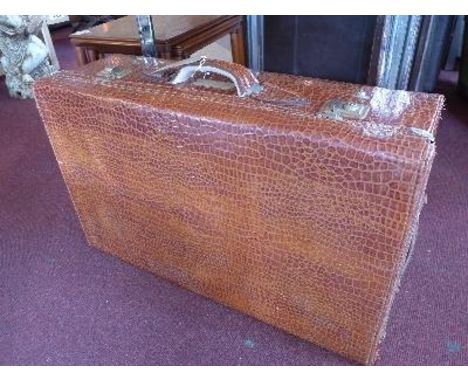 A vintage faux crocodile skin suitcase 