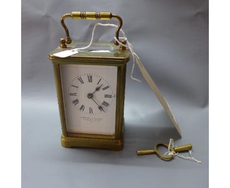 A brass carriage clock, the Roman enamel dial inscribed Walter & George, 270 Regent Circus W, the plain case on bracket feet,