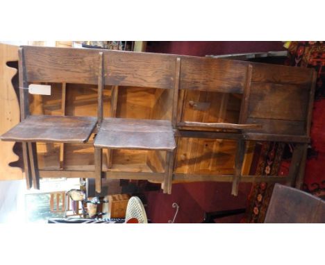 An early 20th century oak folding bench for four 