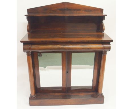 A VICTORIAN ROSEWOOD CHIFFONIER the shelf back above a curved drawer and a pair of mirrored doors, flanked by pillars on a pl