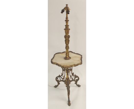 A BRASS TELESCOPIC STANDARD LAMP the triple light fitting above acanthus leaf cast neck with ribbon tied swag mounts, above a