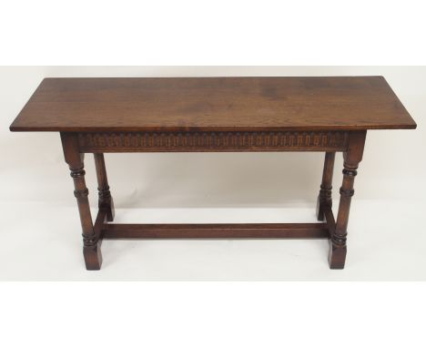 AN OAK HALL TABLE the dentil frieze above ring turned legs, joined by a stretcher, 76cm high, 152cm wide and 46cm deep Condit