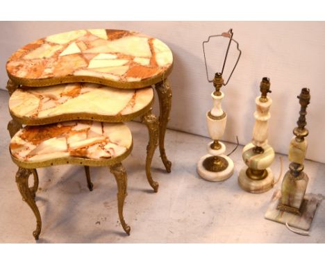 A nest of three kidney-shaped onyx-effect graduated occasional tables, raised on brass supports, largest 44 x 60cm, together 