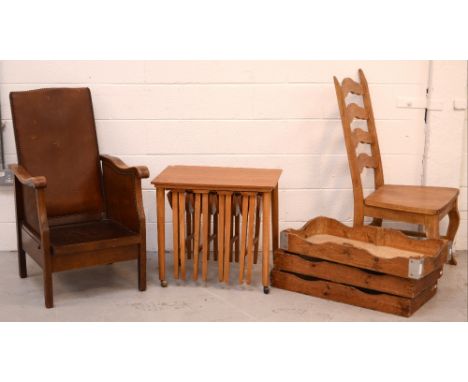 An early 20th century oak reclining armchair, a nest of four folding teak occasional tables, three vintage bread trays and a 