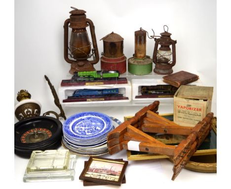 An Art Deco bevelled easel backed mirror, two hurricane lamps, a gilt-framed mirror, a selection of ceramic plates and other 