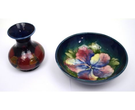 A Moorcroft pomegranate squat baluster vase on dark blue ground, height 9cm and a hibiscus small bowl on dark brown and green