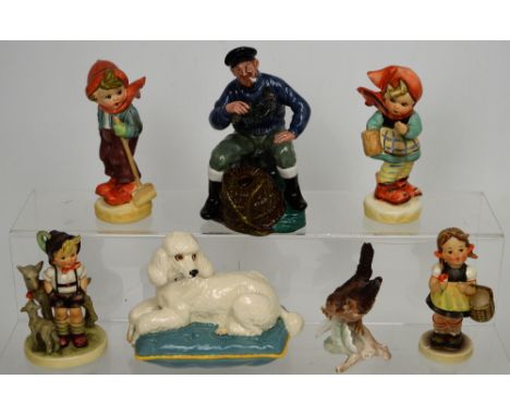 A Beswick model of a poodle on cushion, a Royal Doulton figure HN2317 'The Lobster Man', two Goebel figures, a figure of a bi