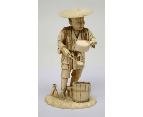 A late 19th century ivory okimono of elderly gentlemen with can and ladle in front of bucket, height 13.5cm.   CONDITION REPO