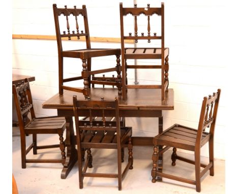 A 20th century oak extending refectory-style table, length 114cm and six Ercol carved and spindle-back chairs (7).