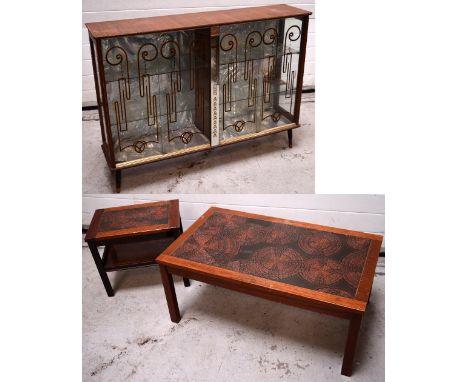 A 1950s teak veneered glazed display cabinet, doors with gold and black decoration, central mirror panelled with leaf decorat