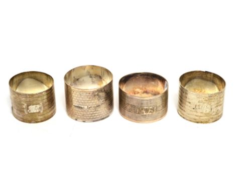 A pair of hallmarked silver napkin rings and two others, all engine-turned.