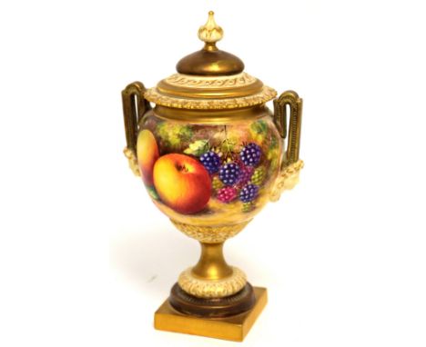 A small Royal Worcester vase and cover, shape 2565, painted with fruit by John Freeman, gilt lid and foot, two-tone handles, 