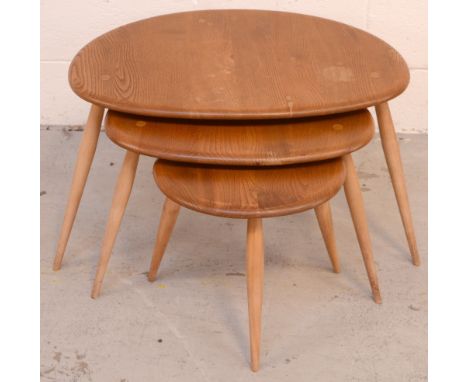 A nest of three Ercol elm pebble tables.