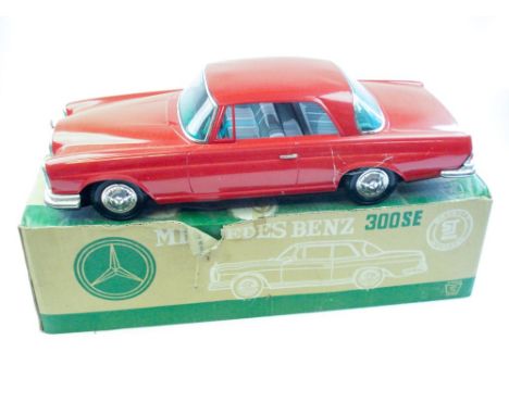 Ichiko (Japan) a large scale friction drive tinplate Mercedes Benz 300SE:, in red with lithographed interior, boxed with orig