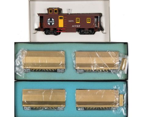 Trains Inc (Japan) Santa Fe side door caboose:, together with four SR hopper cars, unsigned, brass finish, all boxed.