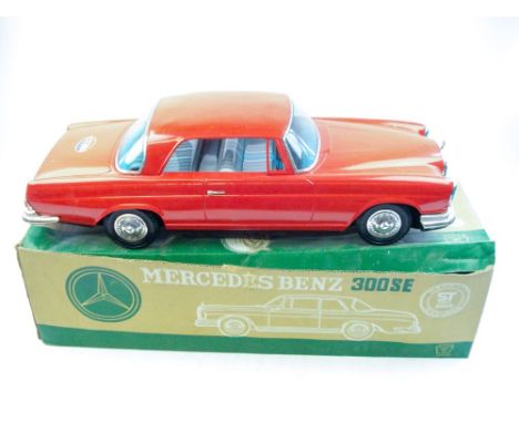 Ichiko (Japan) a large scale friction drive tinplate Mercedes Benz 300SE:, in red with lithographed interior, boxed,(some rus