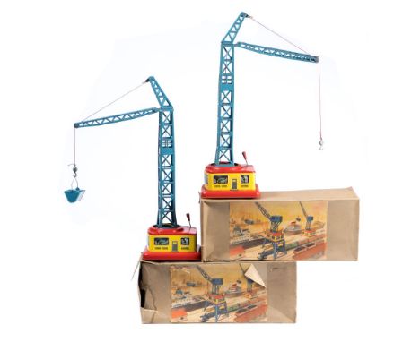 Two West German Post-War tinplate clockwork dockyard crane:, blue tower over lithograph base with black rubber wheels, in ori