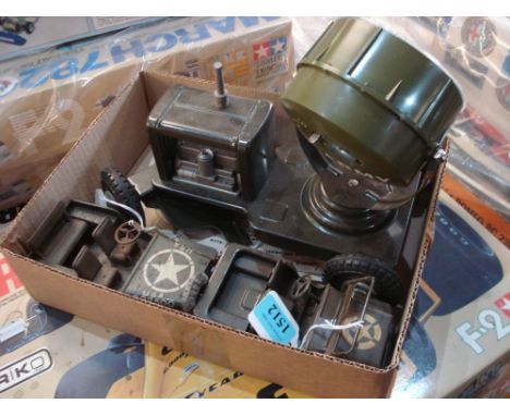 A Tri-ang tinplate clockwork US Army Jeep:, together with an Arnold tinplate jeep and a Marx plastic and tinplate searchlight