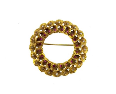 circular with an inner row of round faceted rubies and an outer row of single cut diamonds, diameter 3.8cm, pin and revolver 