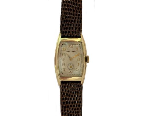 circa 1936, the signed tonneau shaped cream coloured dial, 19mm wide, with gold coloured Arabic numerals and hands, subsidiar