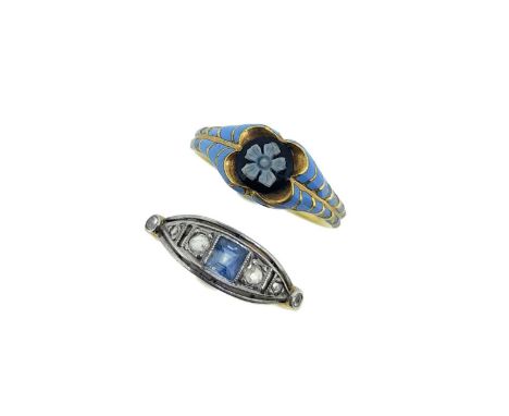 first, a memorial ring with a central black and white forget-me-knot, tapered blue enamel scalloped shoulders, grooved shank,